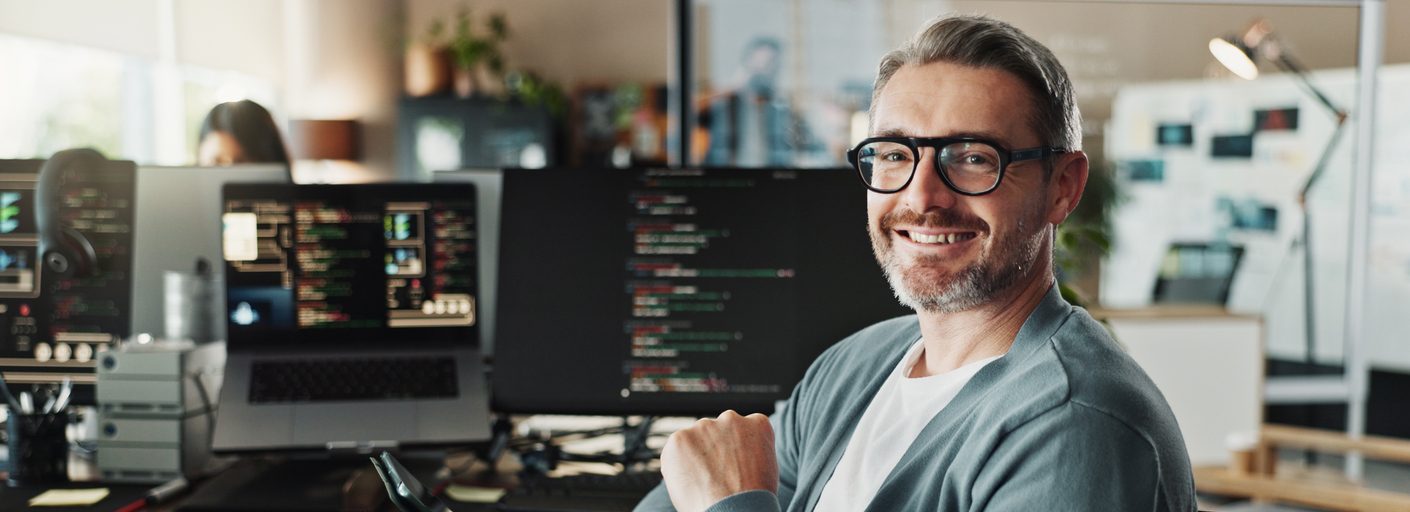 Professionnel en TI analysant des systèmes informatiques dans un environnement de bureau. Illustration des enjeux de protection et d’assurances pour les entreprises technologiques au Québec.