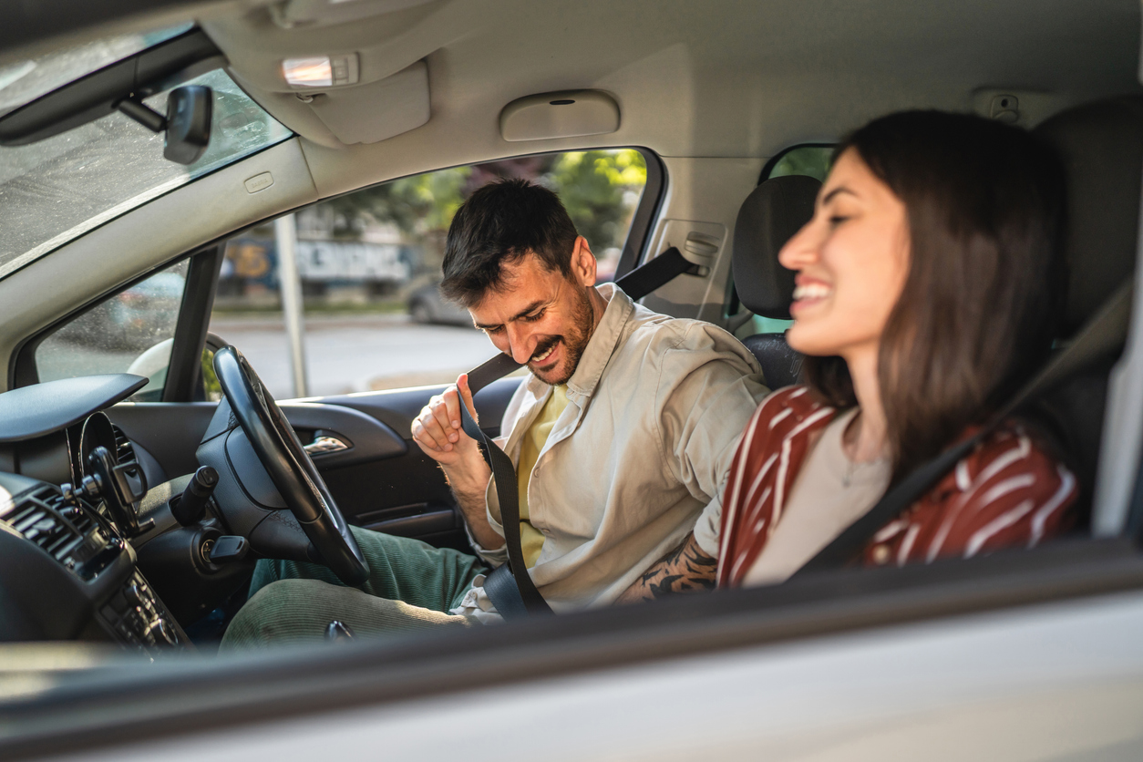 Two occupants in the front seats of a vehicle, seat belts fastened, dashboard visible. Illustration of safe driving for auto insurance. Two occupants in the front seats of a vehicle, seat belts fastened, dashboard visible. Illustration of safe driving for auto insurance.