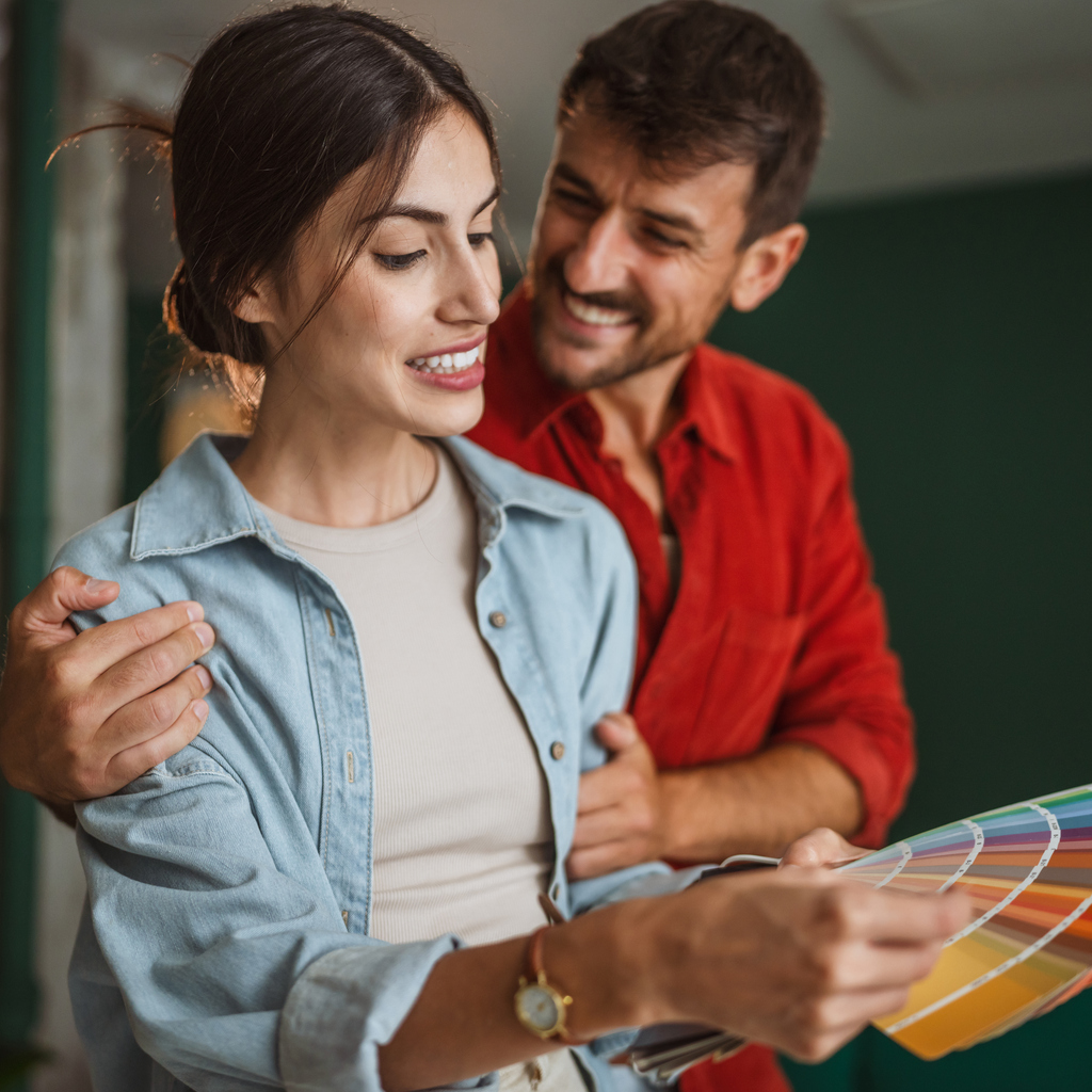 Homeowners assess interior finishing options inside their residence. Scene representative of residential life and homeowner insurance.